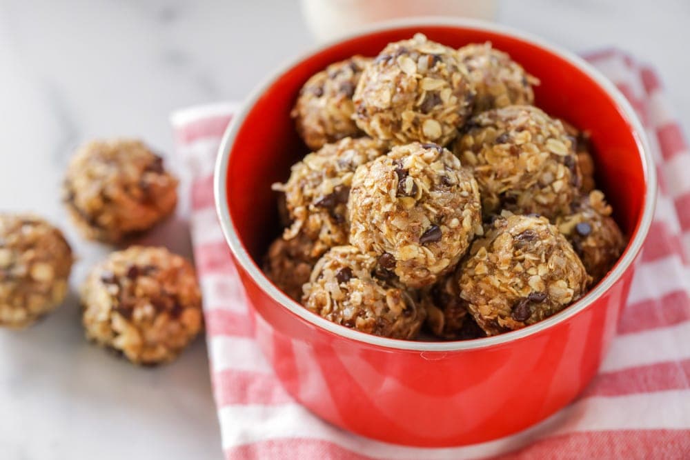 Easy energy balls recipe filling a red bowl.