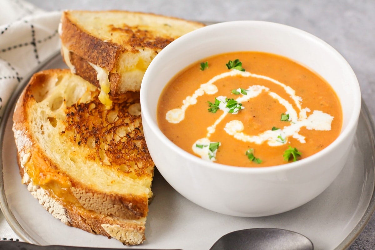 Grilled cheese and tomato soup on plate.