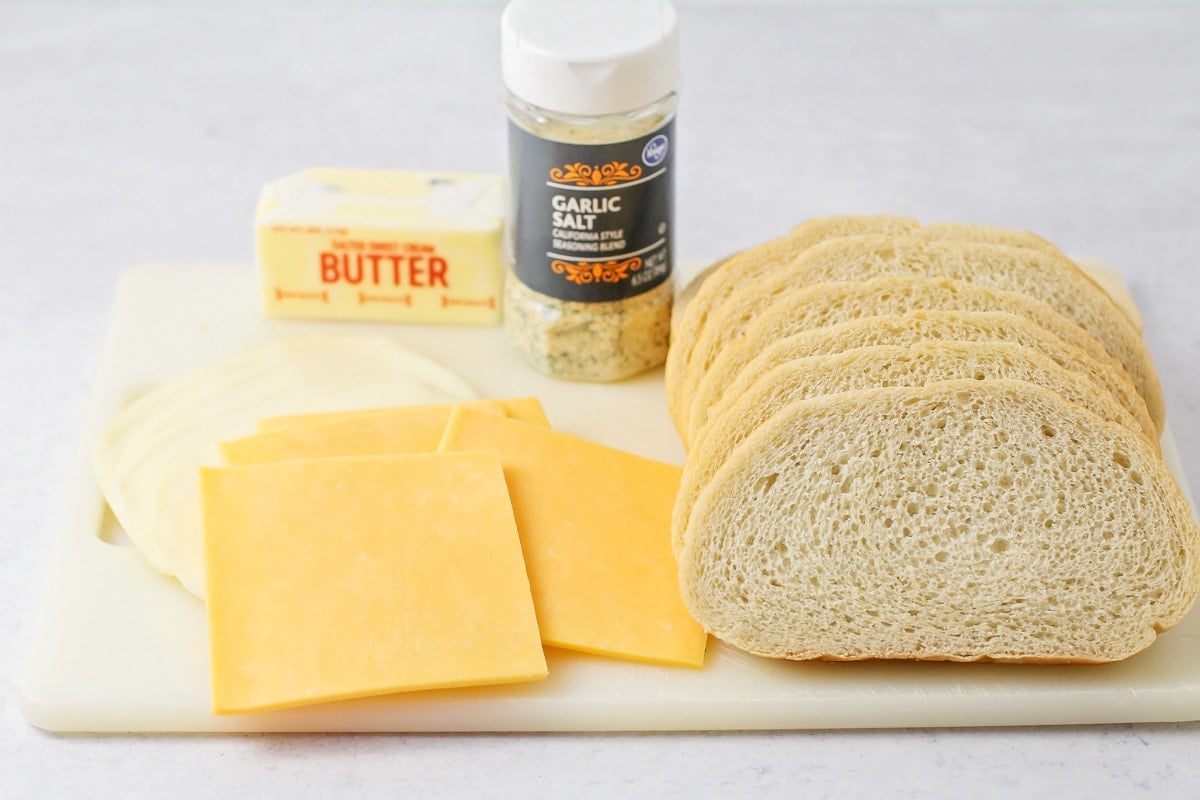 Bread, cheese, and butter on a counter.