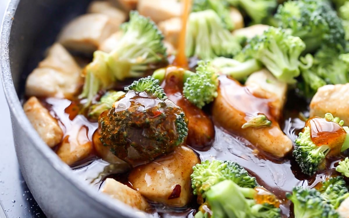 Close up image of broccoli and chicken in honey sauce.