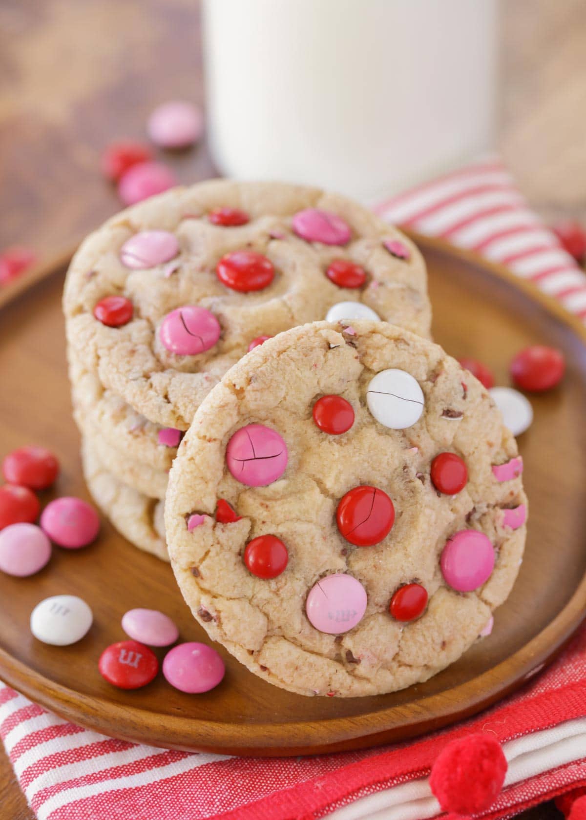 A stack of Valentine Cookies with pink and red M&Ms on top.