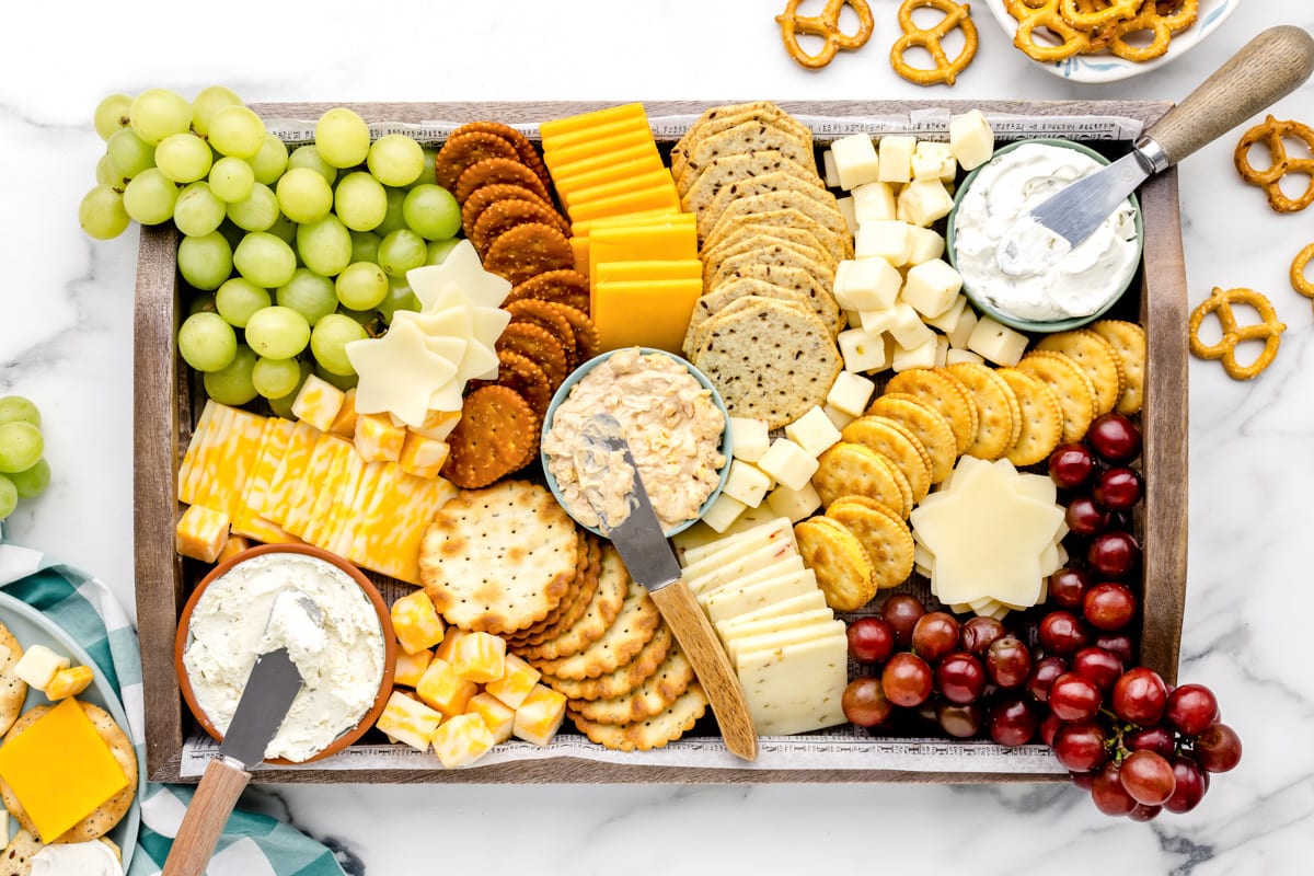 The top view of a cheese and crackers board.