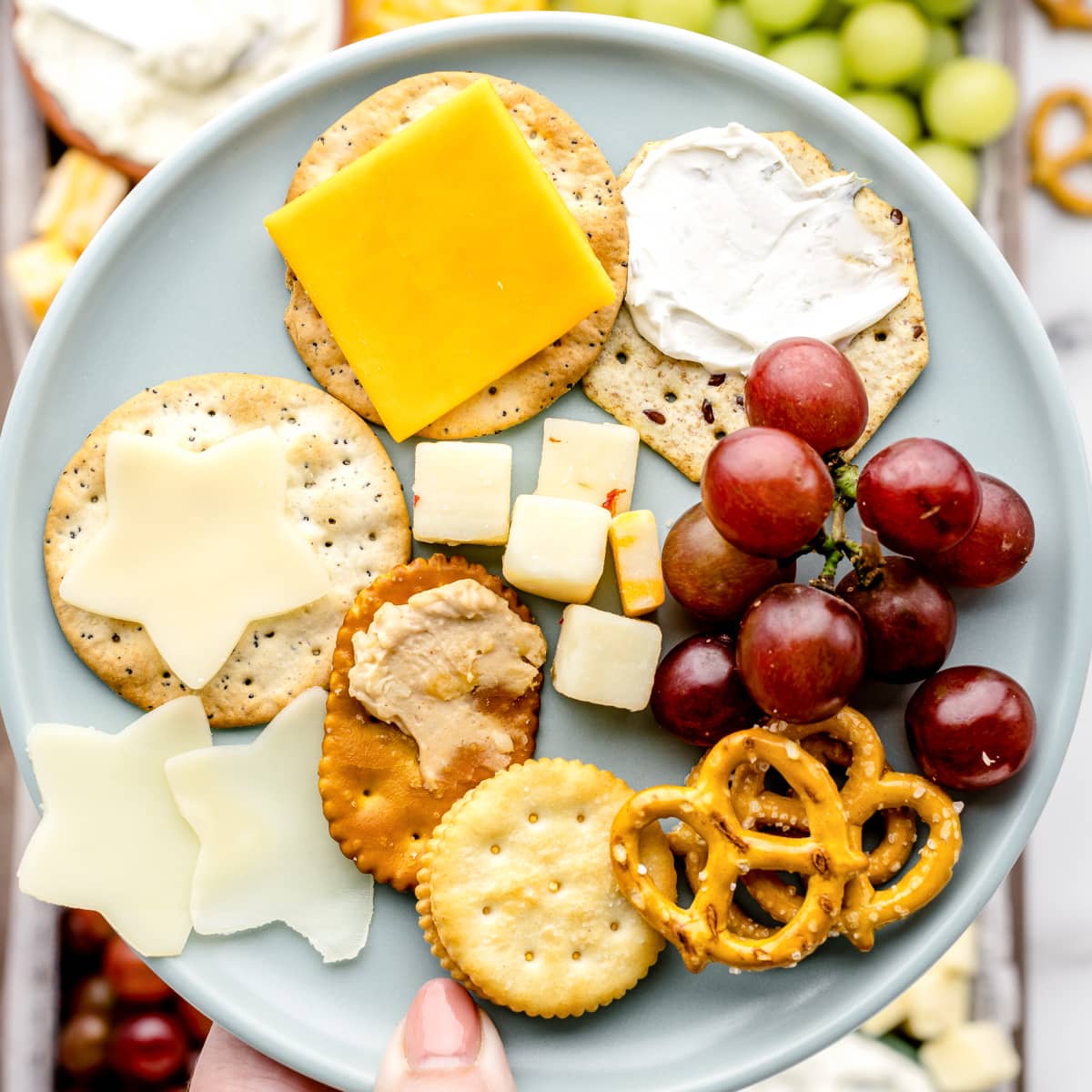A plate filled with cheese and crackers form the board.