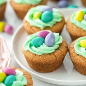 Easter Basket Cookies on white cake stand.