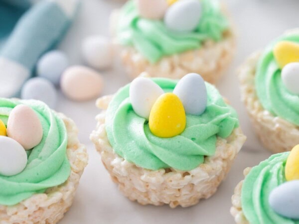 Easter rice krispie treats close up image on counter with more treats and candies.
