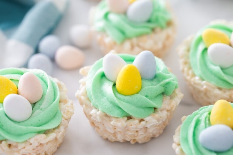 Easter rice krispie treats close up image on counter with more treats and candies.