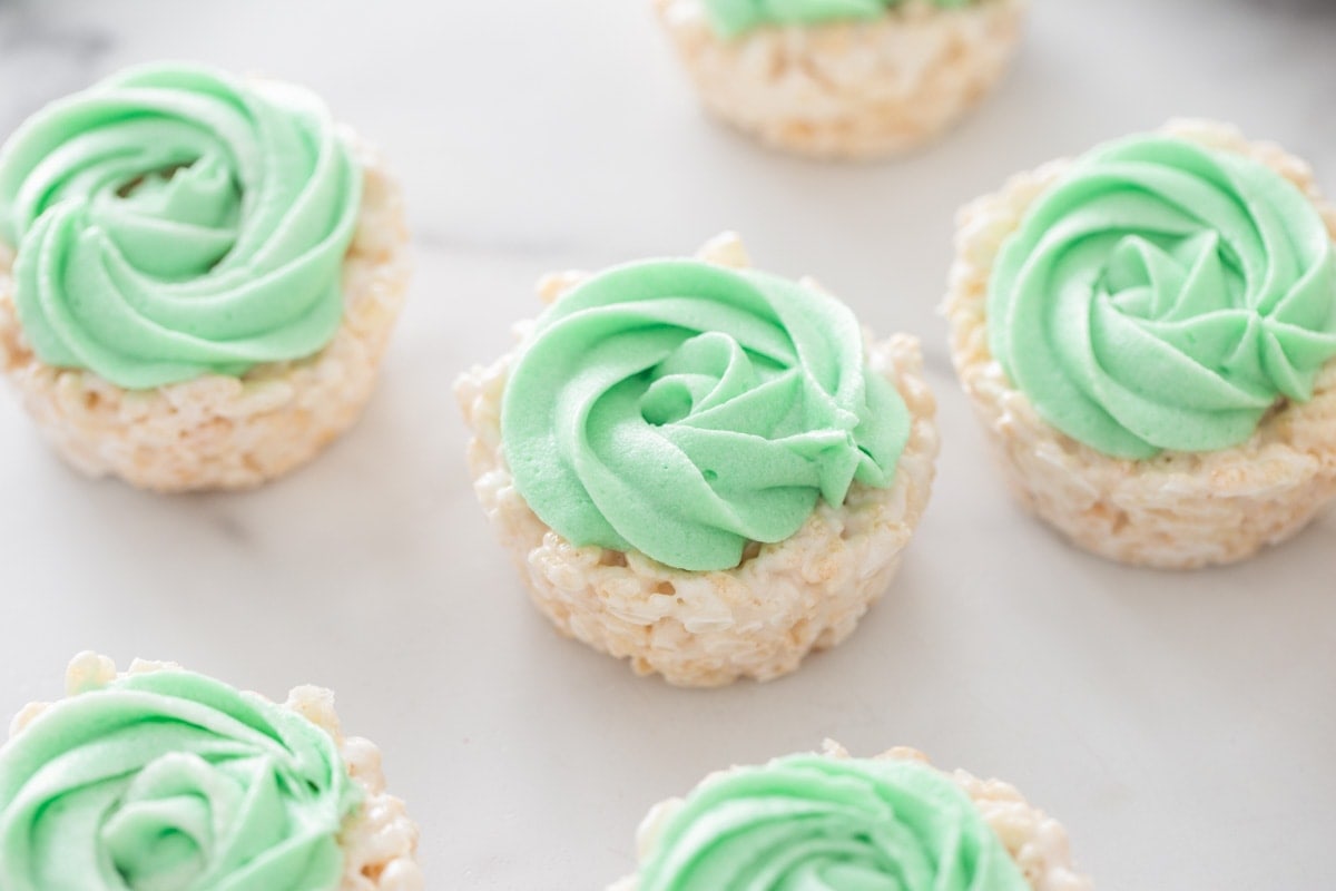 Green frosting on top of Rice Krispie Easter nests.