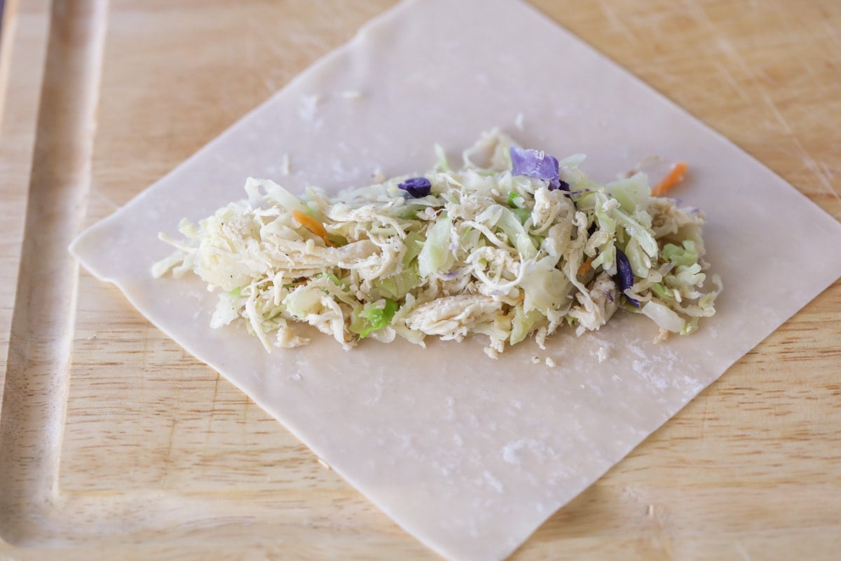 Coleslaw and chicken filling on an egg roll wrapper.
