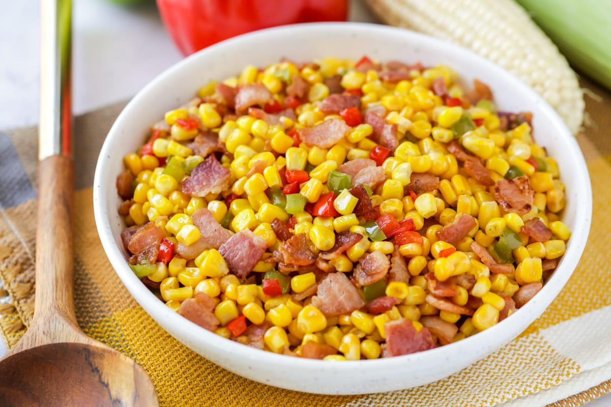 A white bowl filled with colorful fried corn.