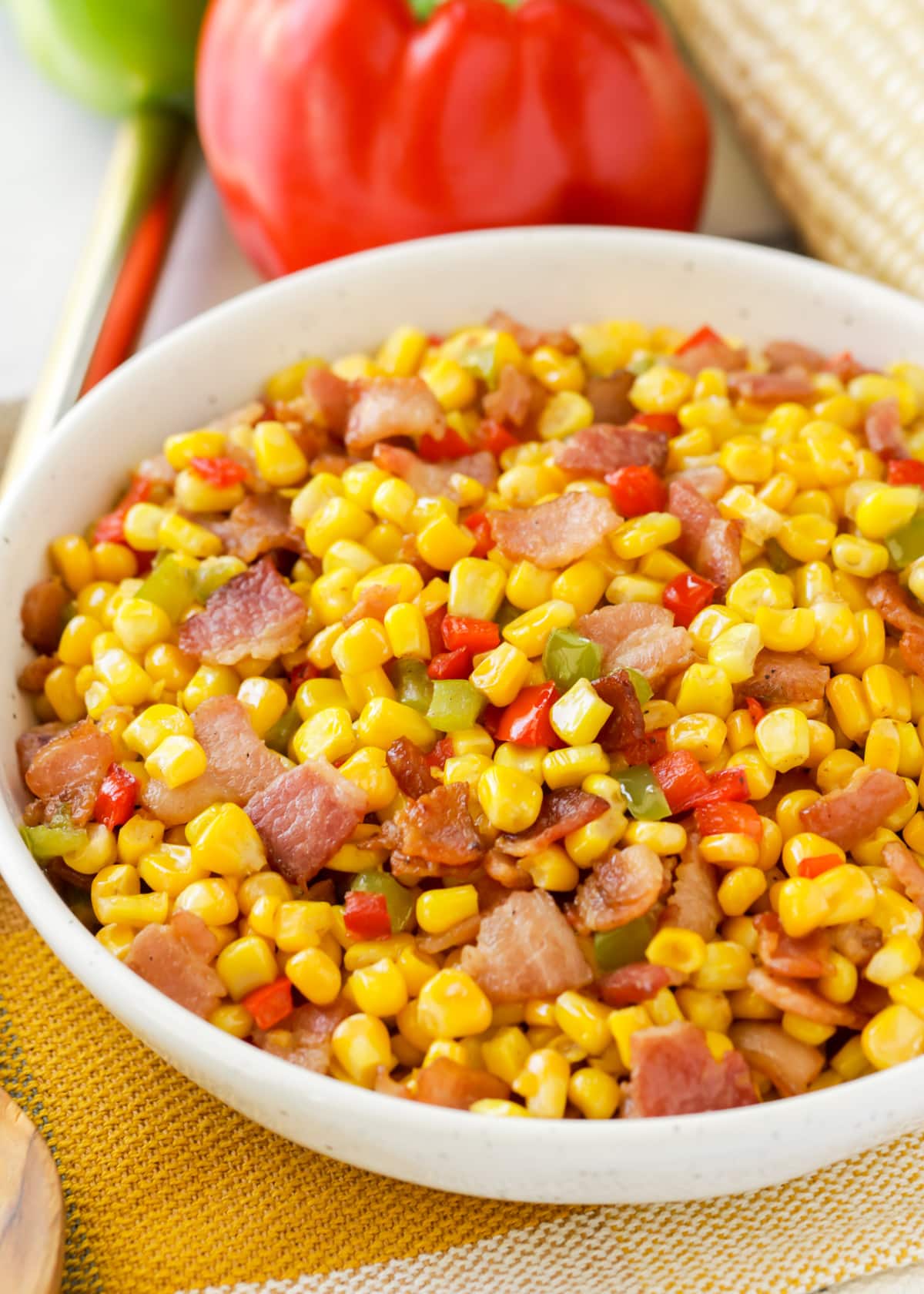 Close up of a white bowl filled with fried corn.