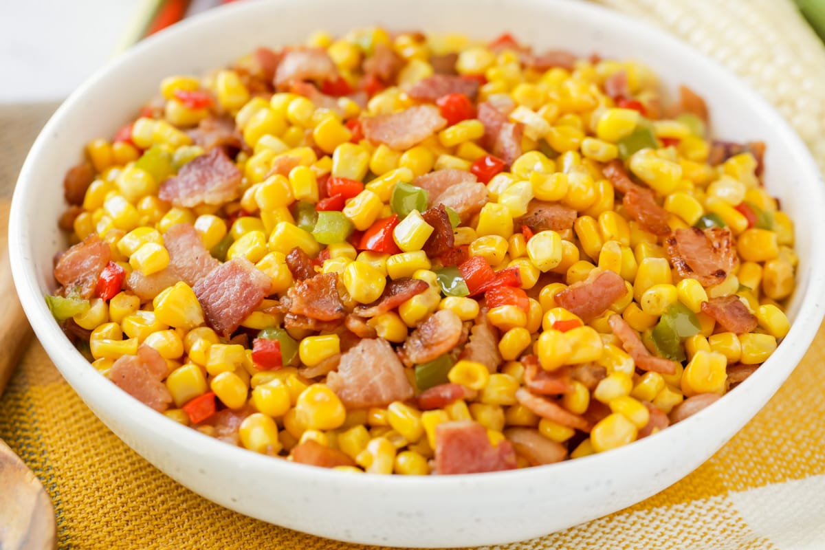 A white bowl filled with fried corn salad.