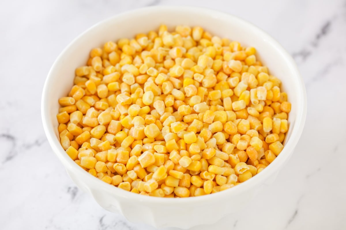 A white bowl filled with corn.