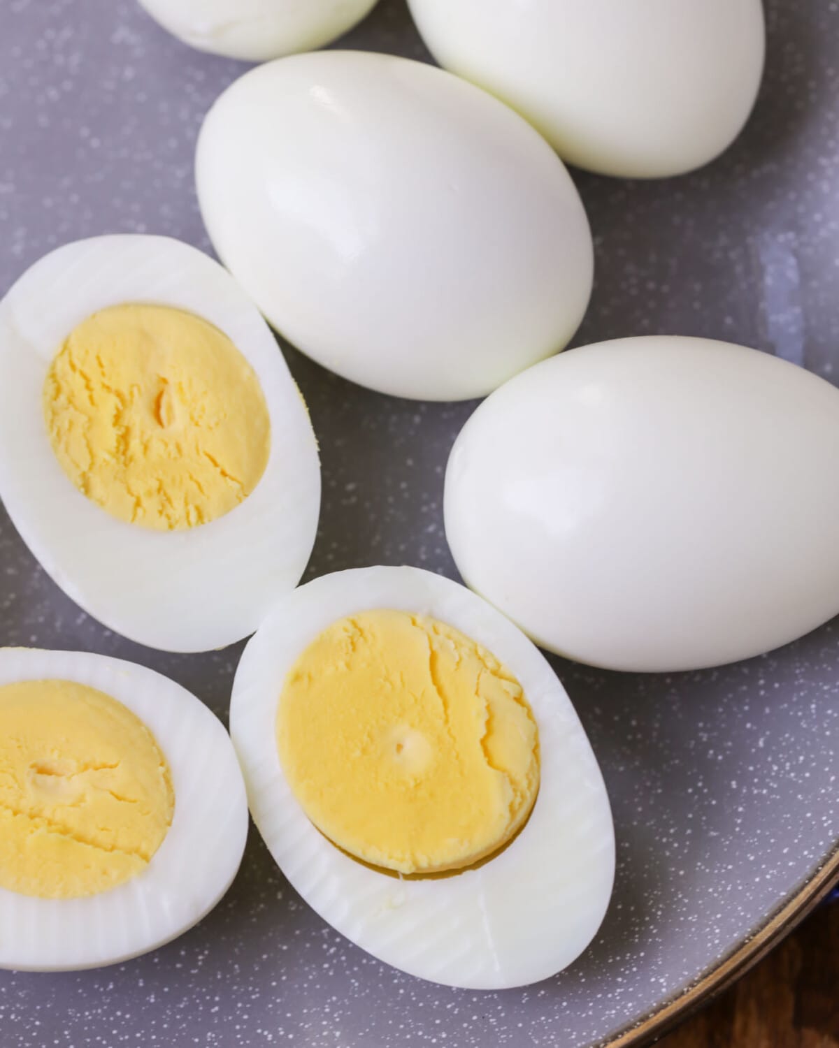 Instant Pot Hard boiled eggs halved and on gray plate.