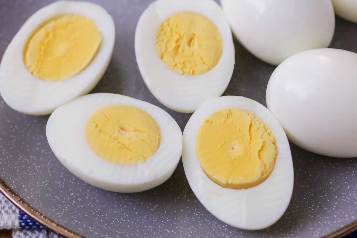 Instant Pot Hard Boiled Eggs peeled and halved on a plate.