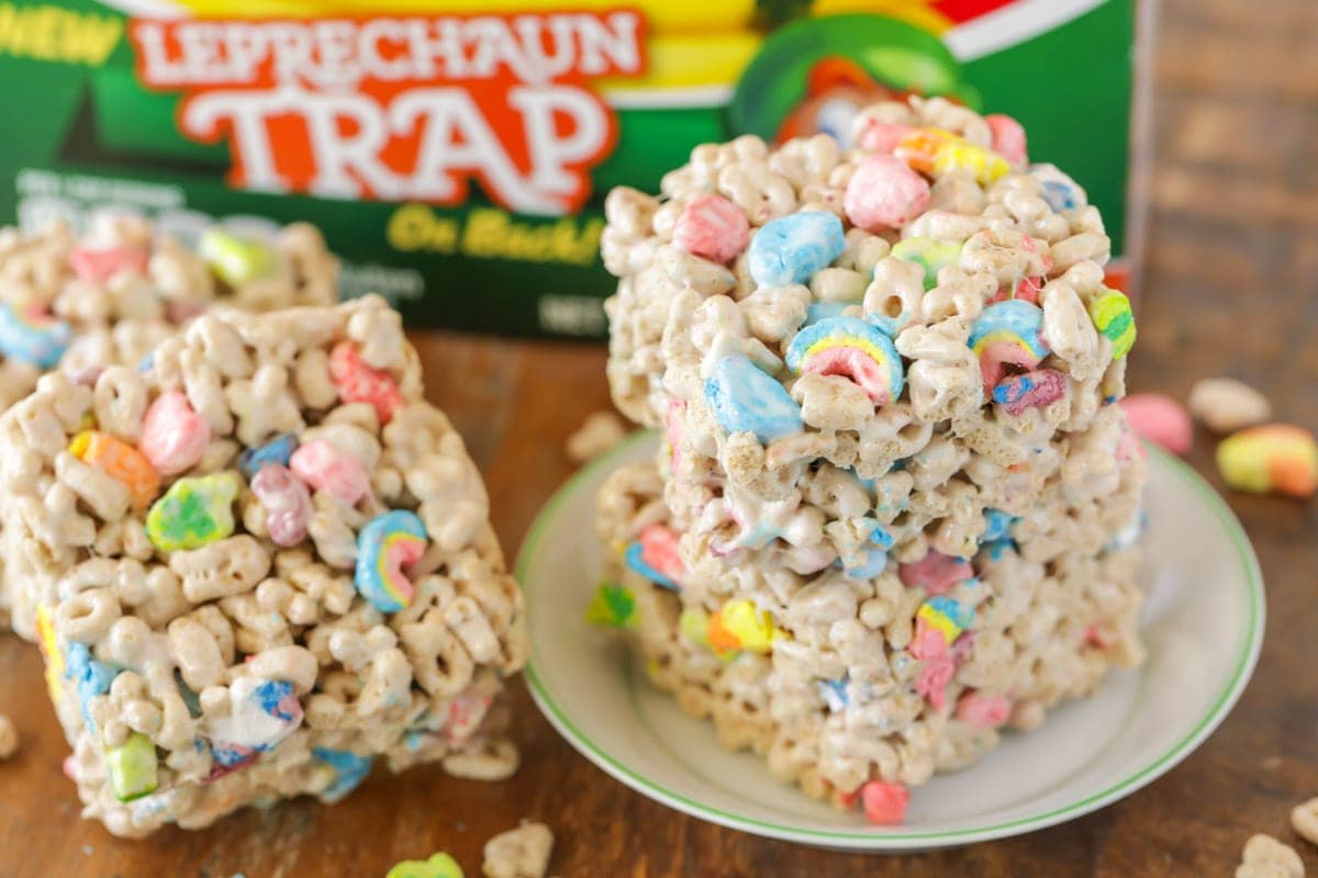 Lucky Charms treats stacked on a small white plate.