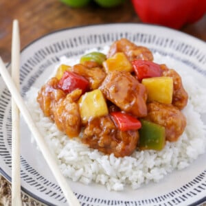 Sweet and sour chicken served over a bed of rice.