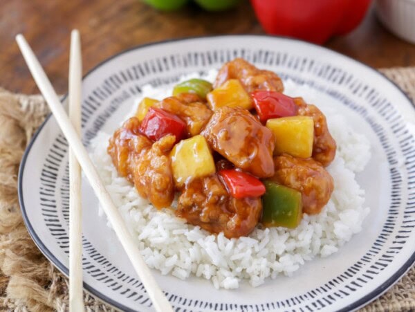 Sweet and sour chicken served over a bed of rice.
