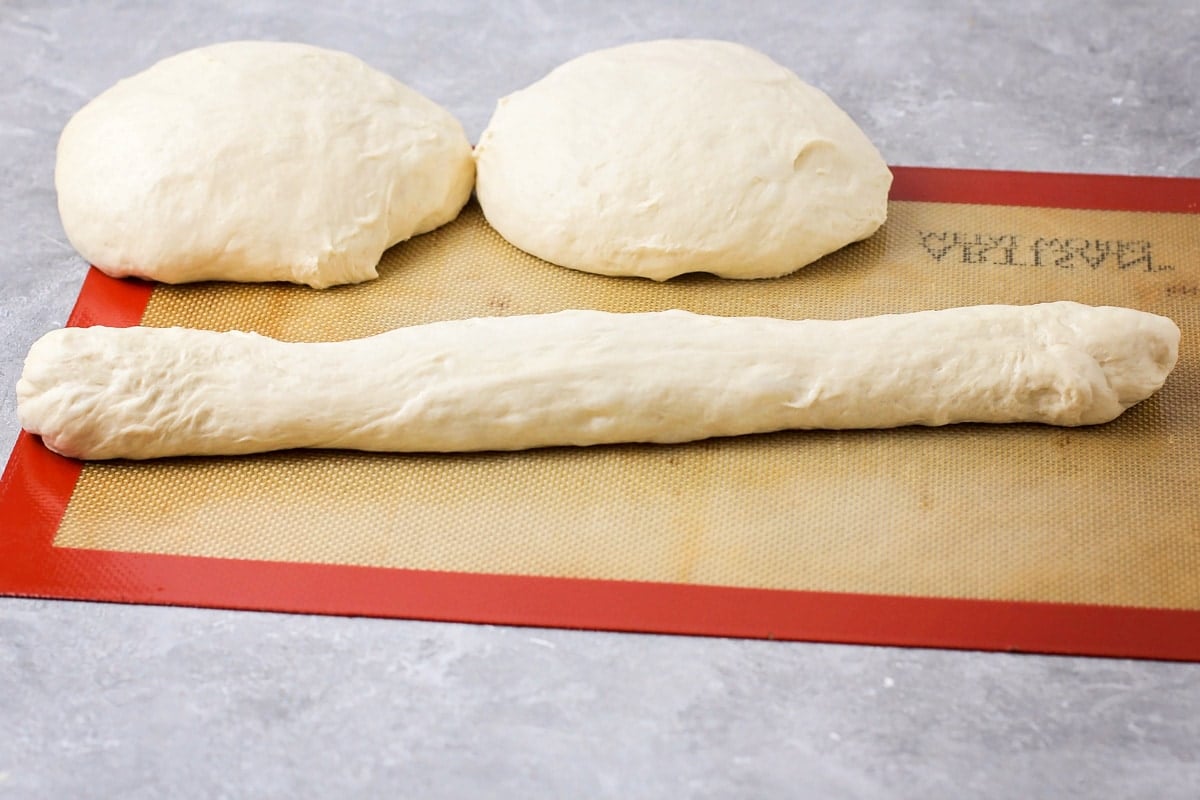 Shaping baguette dough into a loaf.