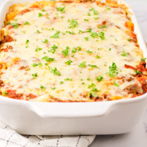 A pan of baked rigatoni covered in cheese.