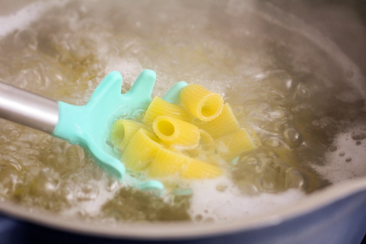Boiling rigatoni in a pot of water.