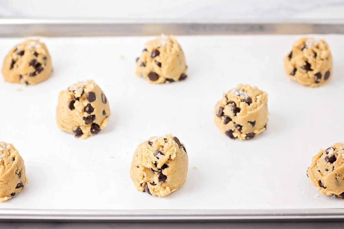 Browned butter chocolate chip cookies scooped onto tray.