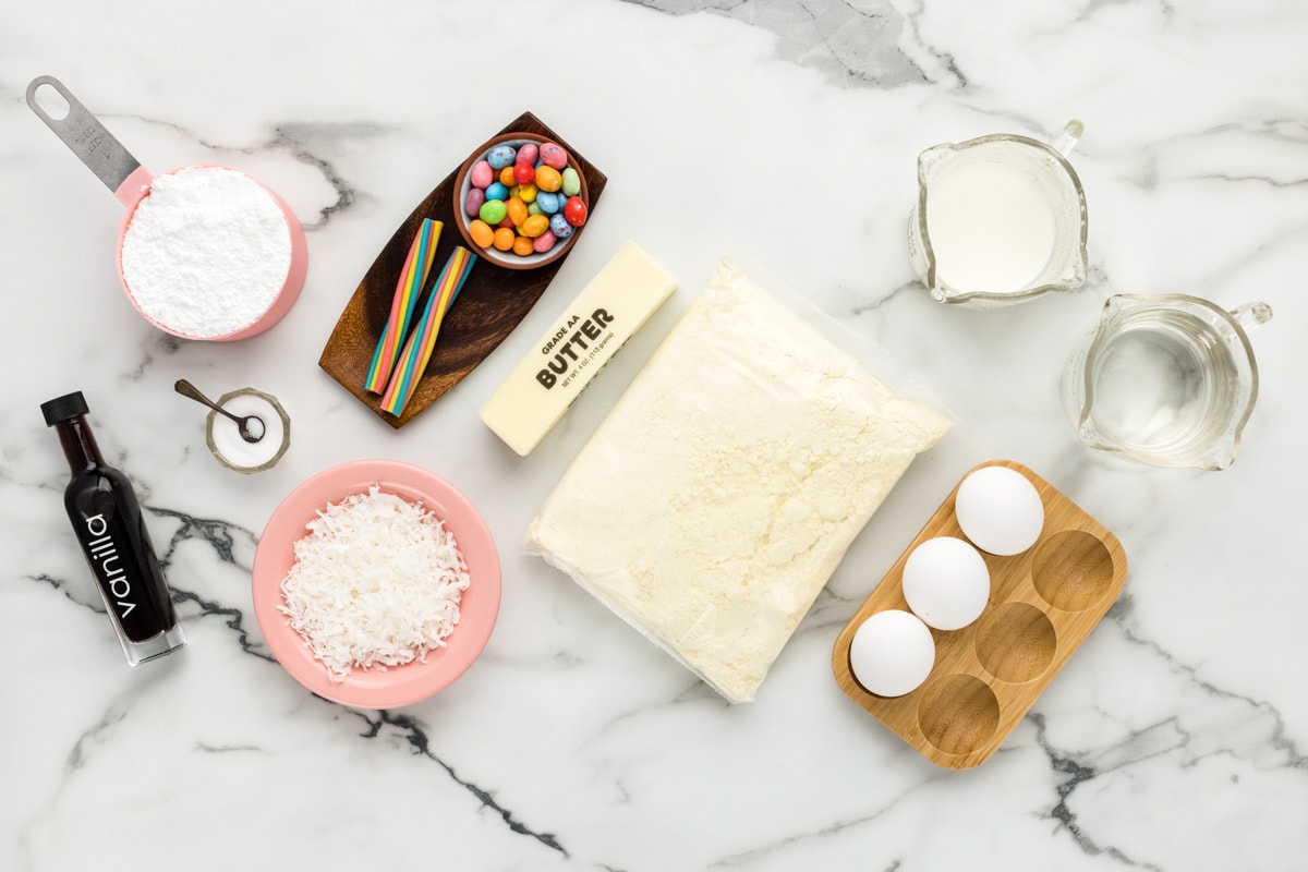 Cake mix, ingredients, and candy on a kitchen counter.