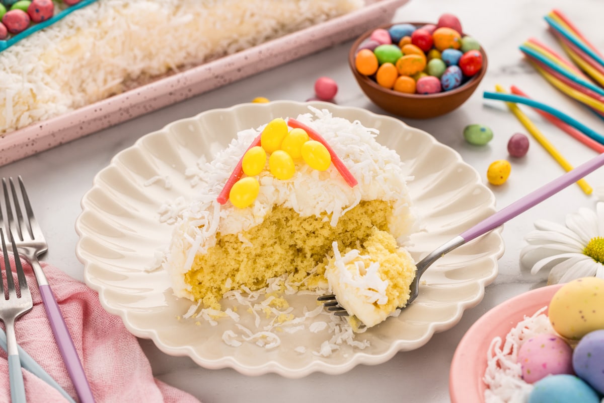 Eating a slice of bunny cake topped with candy.