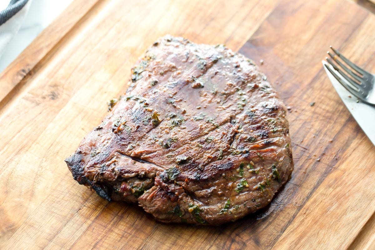 Carne asada meat on a cutting board resting.