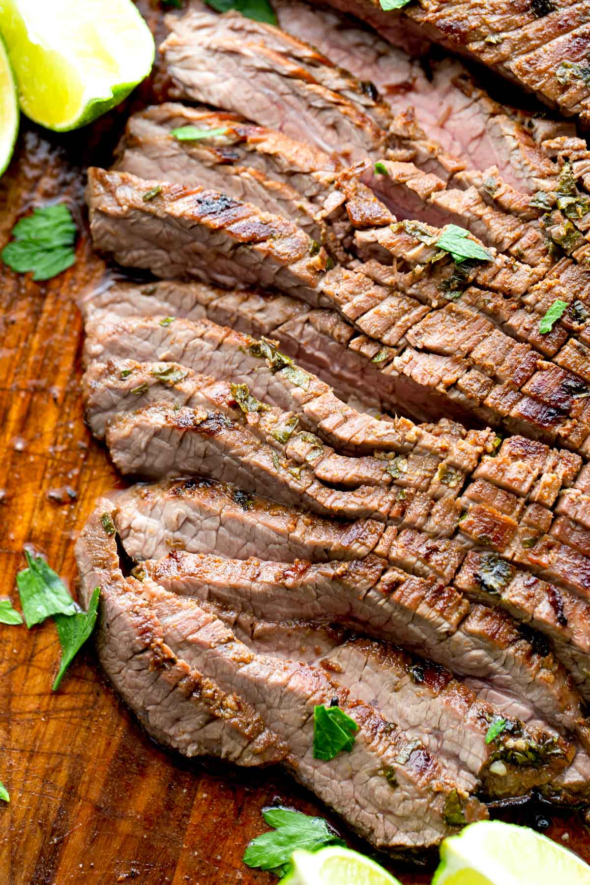 Our favorite carne asada recipe meat sliced on cutting board.