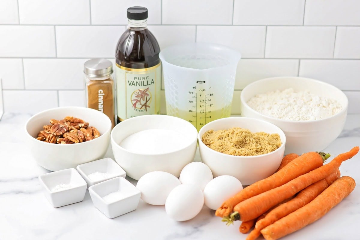 Ingredients for carrot cake cookies on a white countertop.