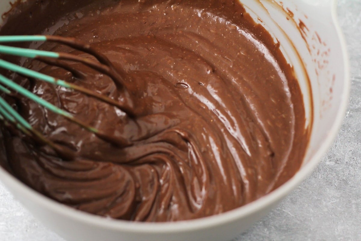Whipping chocolate pudding in a gray bowl.