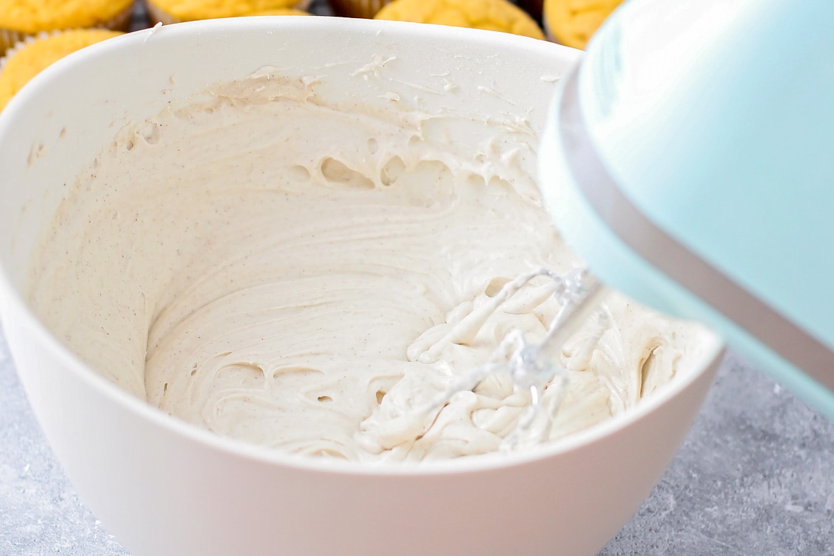 Whipping frosting in a white bowl.