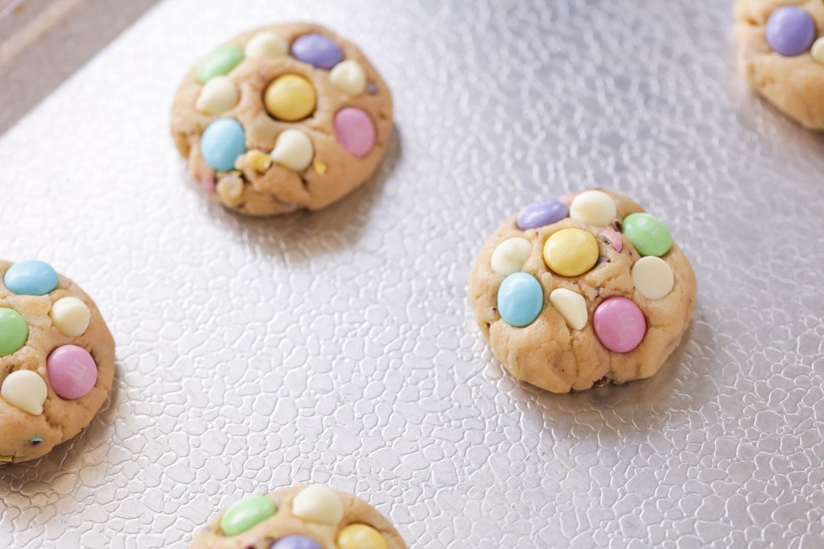 Cookies topped with M&M's and white chocolate chips.