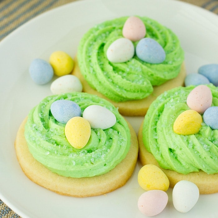 Easter sugar cookies that look like birds nests on a white plate.
