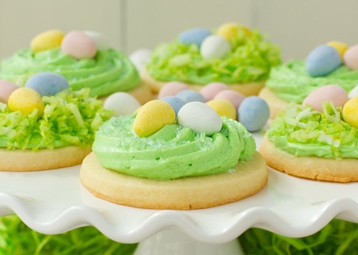 Easter sugar cookies with green frosting and Cadbury eggs on top.