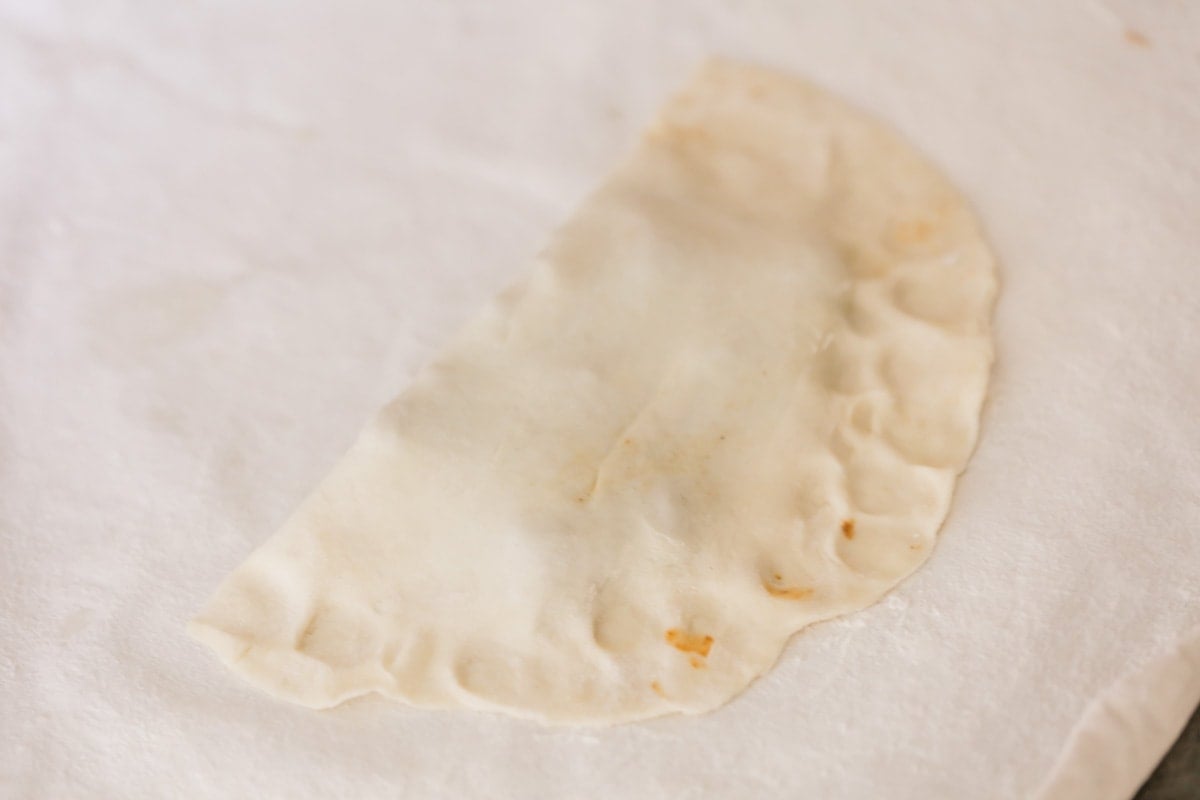 Empanada dough filled and folded over.