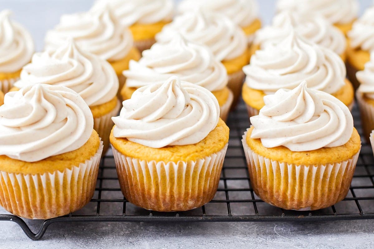 Banana cupcakes topped with cinnamon cream cheese frosting.