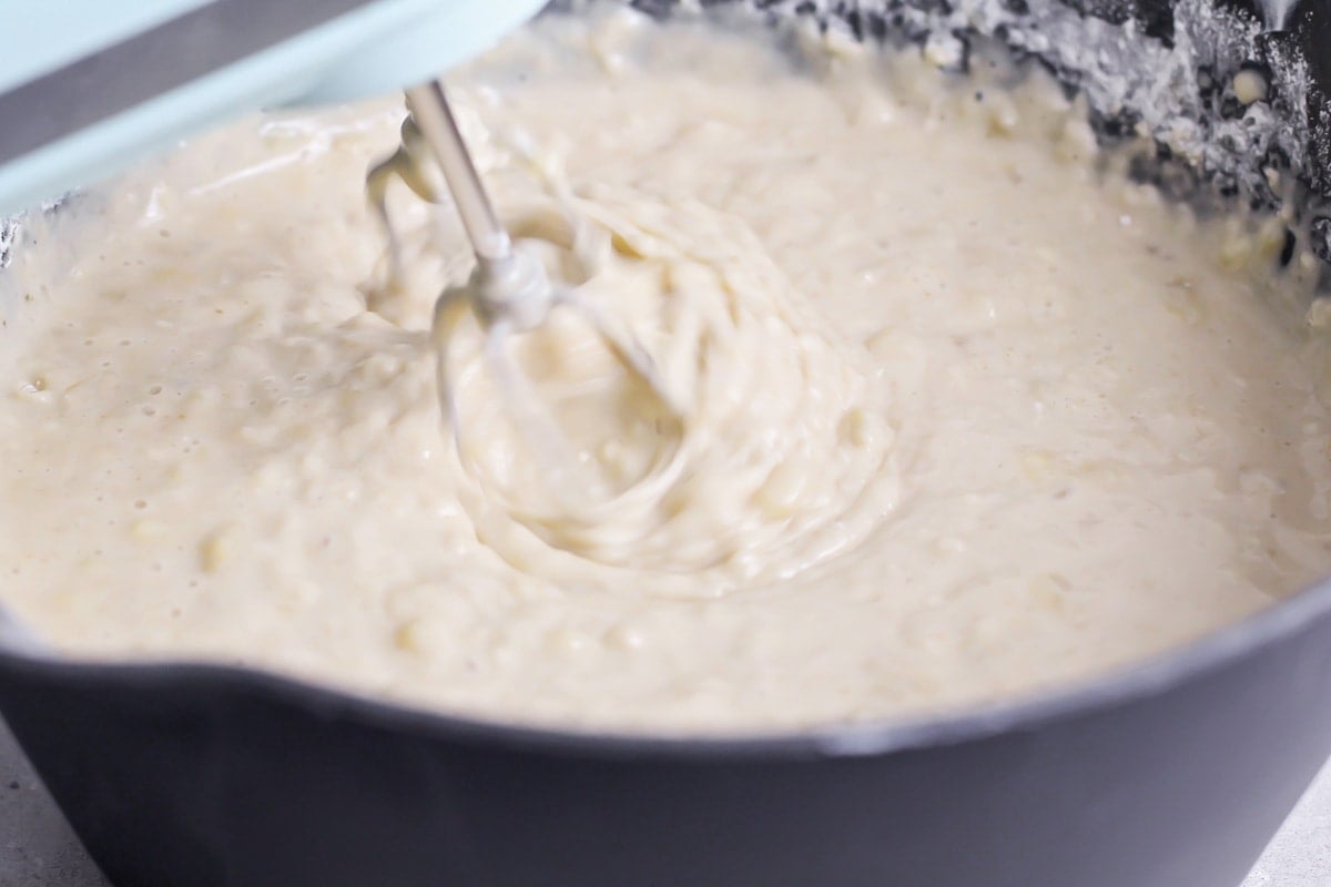 Mixing bread batter with a hand held mixer.