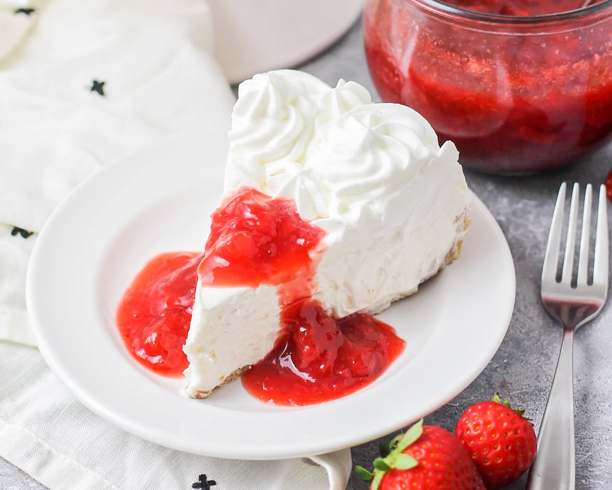No bake cheesecake with homemade strawberry sauce on top.