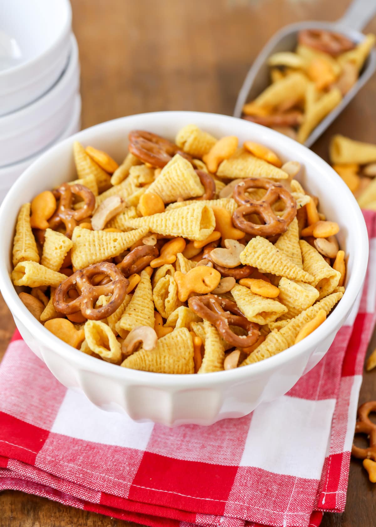 Close up of a white bowl filled with snack mix.