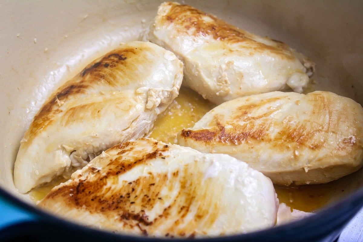 Browned chicken in dutch oven.