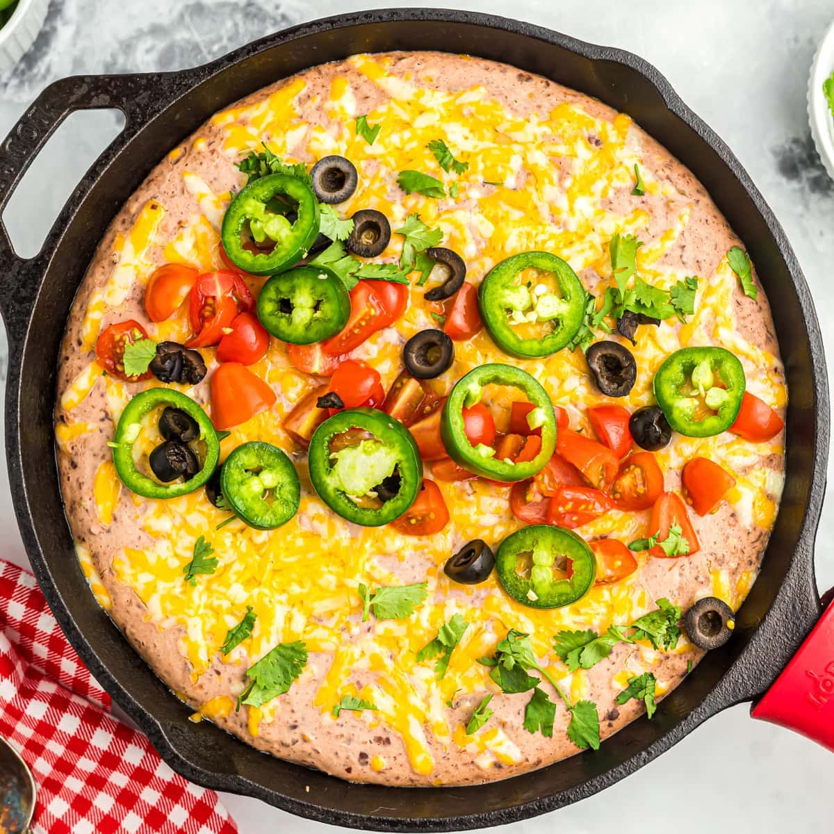 Black bean dip served in a cast iron skillet.
