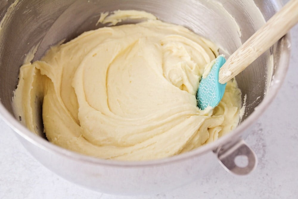 Mixing the caramel cake batter with a spatula.