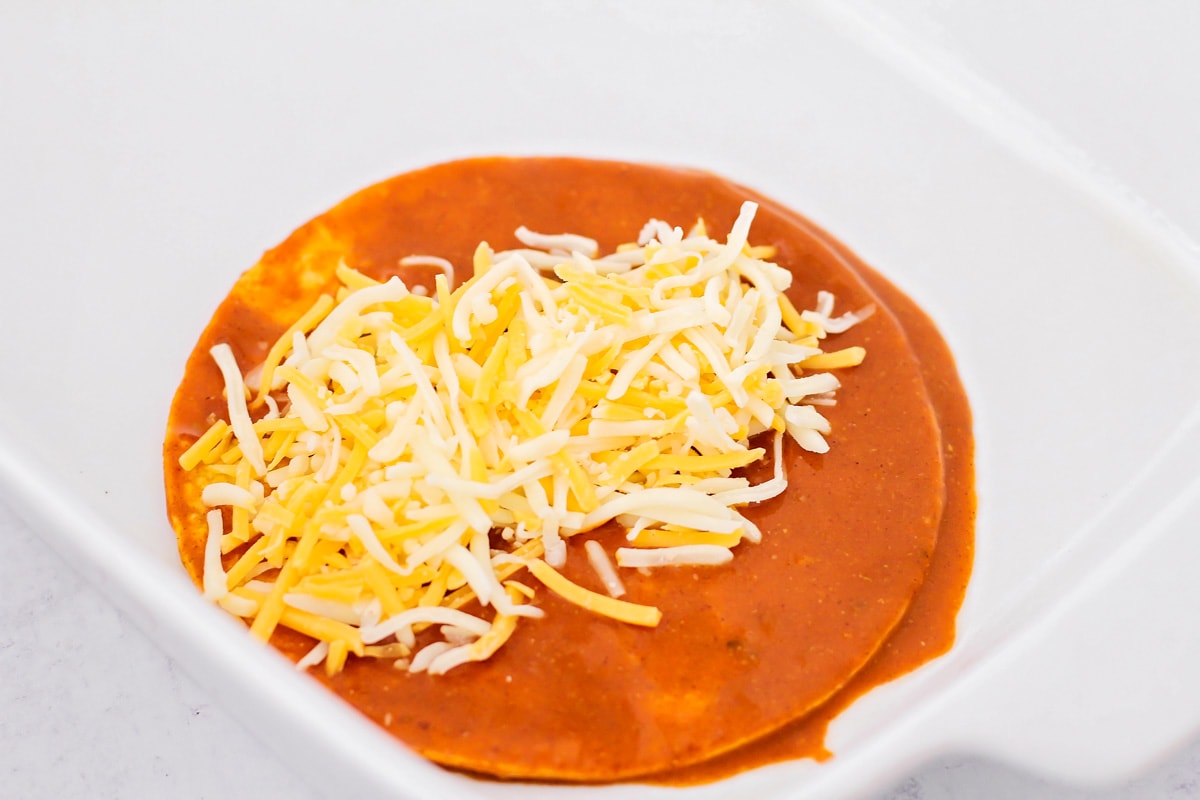 Cheese filled enchilada in baking dish.