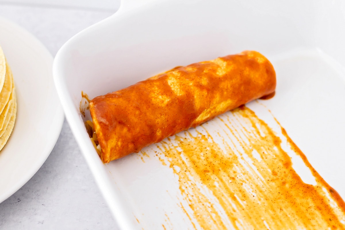 Rolled enchilada in casserole dish.