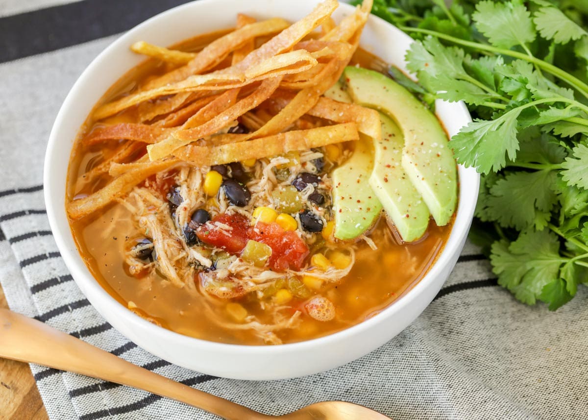 Chicken tortilla soup served in a white bowl.