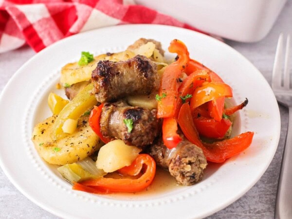 Italian sausage and potatoes served in a white bowl.