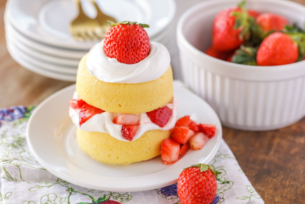Strawberry shortcake topped with fresh strawberries and whipped cream.