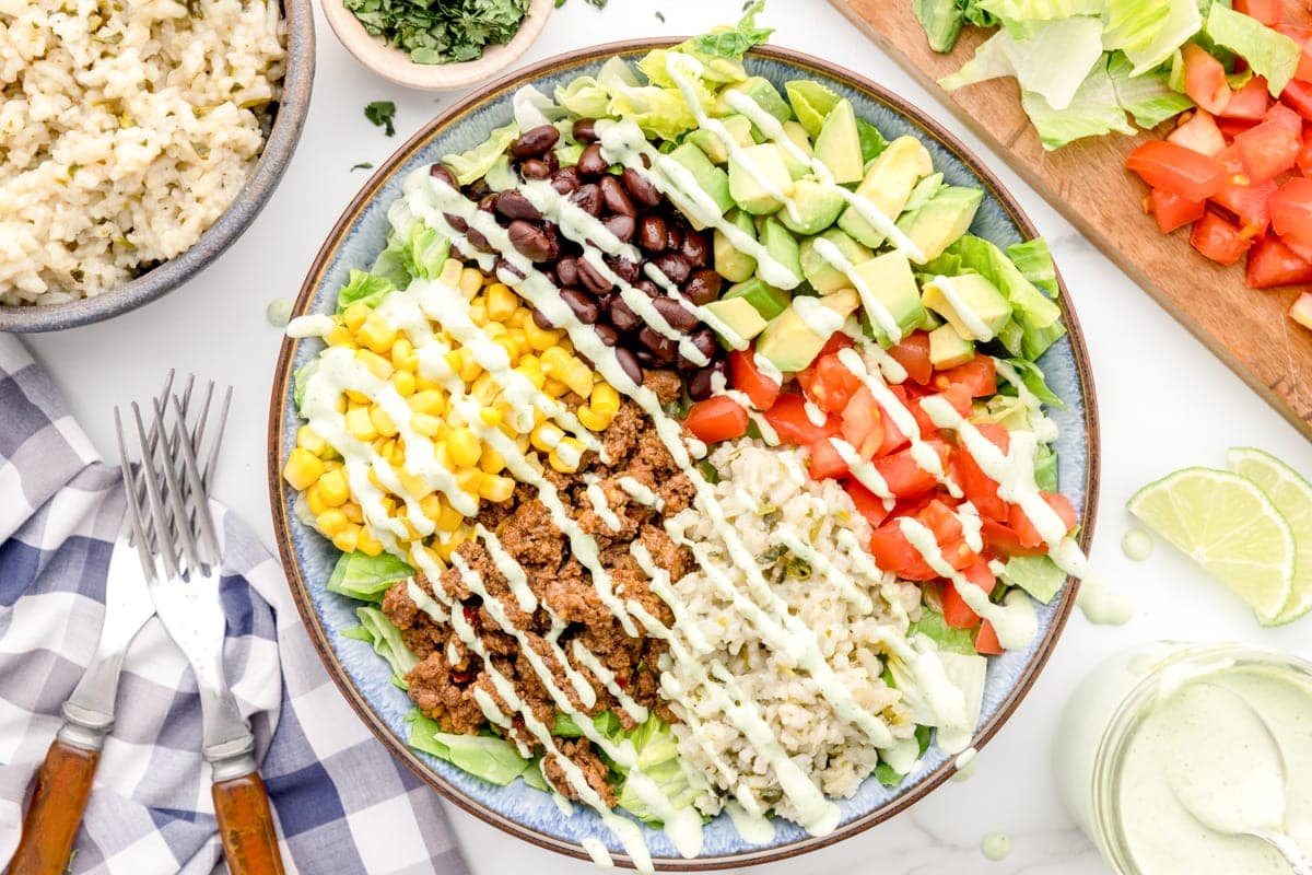 Lightly dressed taco bowl in a blue bowl.