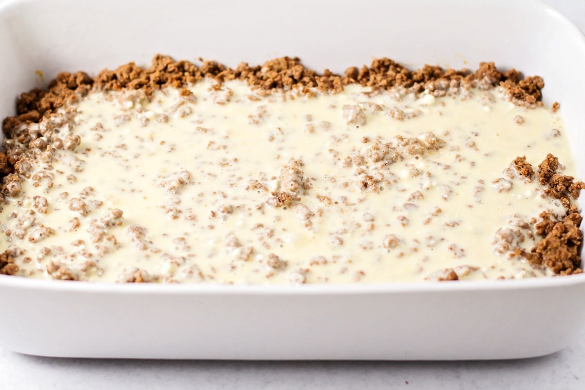 Batter poured over taco meat in casserole dish.